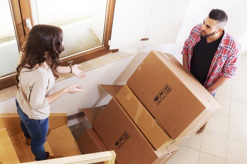Family home move preparation with labelled boxes and protective wrapping